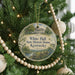 A round ornament hanging on a Christmas tree, featuring a picture of the White Hall State Historic House in Kentucky.