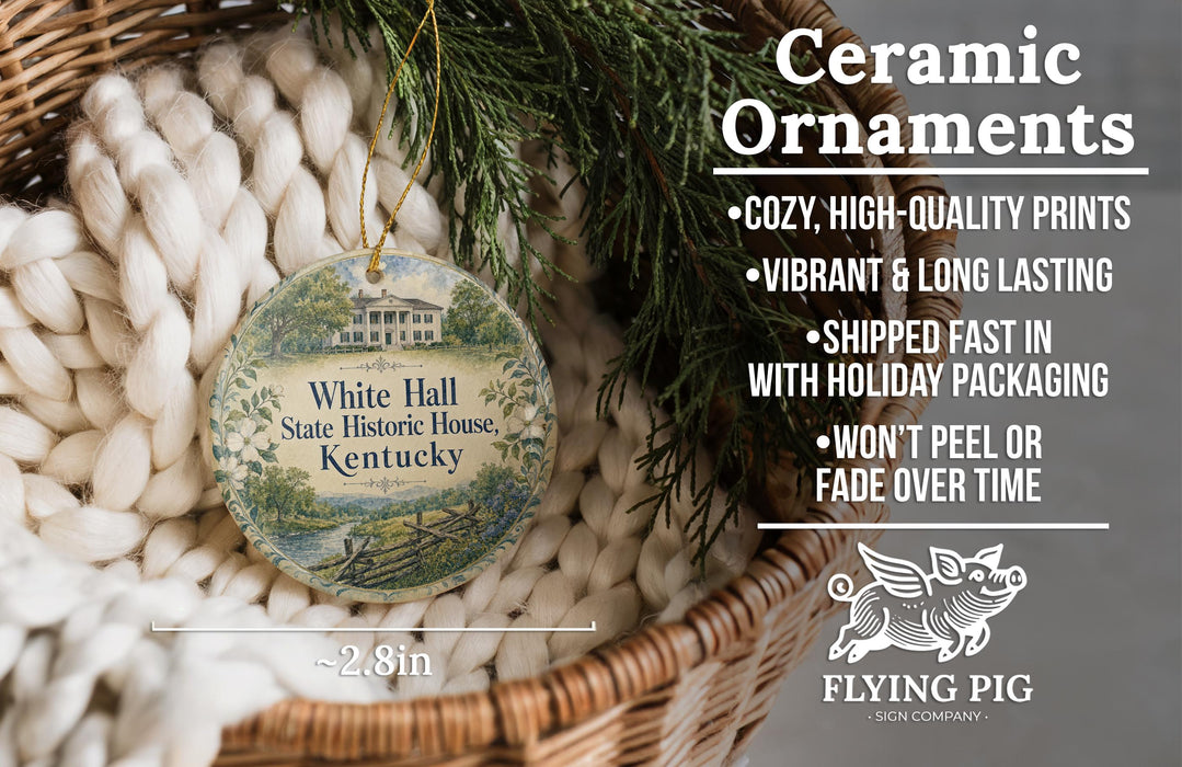 Ceramic ornaments, featuring a round ornament with a house design, are displayed in a basket with greenery.