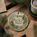 A decorative ornament featuring a scenic landscape of White Oak Lake State Park in Arkansas, with pine branches and a cup of coffee nearby.