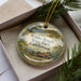 A decorative ornament in a box, featuring a scenic landscape with a house and trees, with the text "Wilder Ranch State Park, California" prominently displayed.