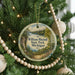 A round ornament hanging on a Christmas tree, featuring a scenic image of William Mitchell State Park, Michigan.