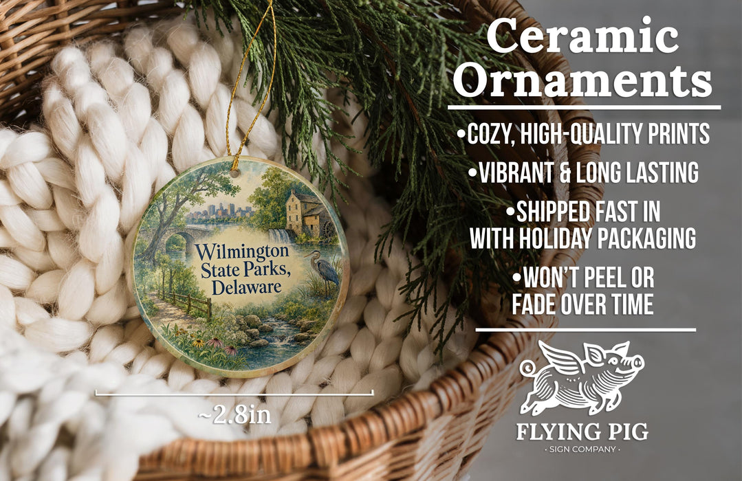 Ceramic ornaments, featuring a painting of a scenic view of Wilmington State Parks, Delaware, hanging in a woven basket.