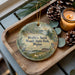 A wooden tray with a decorative ornament featuring a scenic image of Wolf's Neck Woods State Park, Maine, and pine cones.