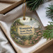 A decorative ornament with a scenic landscape of Wompatuck State Park, Massachusetts, featuring a bird perched on a tree branch and a winding path leading through the forest.
