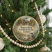 A round ornament hanging on a Christmas tree, featuring a scenic image of the Woodson Bridge and the Woodson State Recreation Area in California.