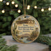 A round ornament featuring an illustration of Quartermaster Depot, a historic building in Arizona, surrounded by desert elements such as a cactus and a bridge.