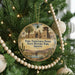 A round ornament hanging on a Christmas tree, featuring an illustration of Yuma Territorial Prison State Historic Park, Arizona.