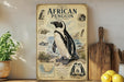 a poster of an African penguin on a shelf, surrounded by various kitchen utensils and a potted plant.