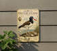 a sign for the American Oystercatcher, which is a bird species. The sign is mounted on a wall and depicts the bird in a natural setting, with a shell and a bird in the background.