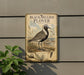 a vintage-style sign depicting a black-bellied plover bird standing on a grassy area with a body of water in the background.