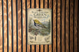 A vintage-style sign featuring a black-throated green warbler bird on a pine branch, with pine cones and pine needles in the background.