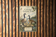 A vintage-style poster of two Canadian geese, with text and illustrations, is displayed on a wooden wall.