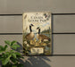 A vintage-style metal sign with a depiction of a Canadian goose and its ducklings, surrounded by nature elements such as pine trees and flowers.