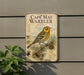 a vintage-style metal sign with a bird illustration, mounted on a wall next to a plant.