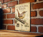 a vintage-style metal sign with illustrations and text, mounted on a brick wall.