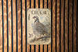 a vintage-style poster of a chukar, a type of bird, displayed on a wooden wall.