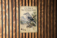 A metal sign with a bird illustration and text, mounted on a wooden wall.