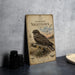 a poster of a Common Night hawk, a bird of prey, sitting on a branch with a detailed illustration of the bird and its natural habitat.