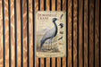 a poster of a demoiselle crane, a large wading bird, mounted on a wooden wall.