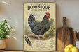 a vintage-style poster of a Dominique chicken, with a detailed illustration of the bird and its surroundings. The poster is displayed on a shelf next to a wooden cutting board and a potted plant.
