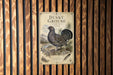 a metal sign with a detailed illustration of a grouse bird, mounted on a wooden wall.