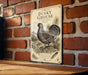 A metal sign with a vintage-style illustration of a grouse bird, mounted on a brick wall.