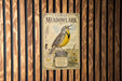 a vintage-style sign for the Eastern Meadowlands, depicting a yellow bird with a black head and wings.