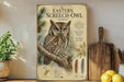 a poster of an Eastern Screech- Owl on a wall, with a potted plant to the left and a wooden cutting board to the right.