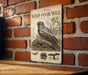 a vintage-style illustration of a bird, likely a Whip-poor-Will, perched on a tree branch against a brick wall background.