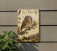 an ornate, vintage-style sign depicting an elf owl, with illustrations of the owl, pine trees, and mountains in the background.