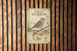 a vintage-style metal sign with illustrations and text, mounted on a wooden wall.
