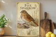 a vintage-style poster of a brown and white spotted bird, likely a fox sparrow, perched on a branch with berries. The poster is displayed on a shelf next to a wooden cutting board and a potted plant.