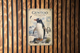 a poster of a penguin, with a detailed illustration of the penguin and its natural habitat, including a snowy landscape and a body of water.