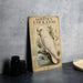 A vintage-style poster of a white cockatoo, featuring detailed illustrations and text, is displayed on a gray wall next to a stack of black camera lenses.