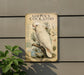a vintage-style metal sign with a detailed illustration of a white cockatoo perched on a branch, surrounded by various bird-related elements.