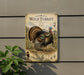 A metal sign with a turkey illustration on it, mounted on a wall.