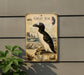 a vintage-style metal plaque depicting a penguin, with a plant in the foreground.