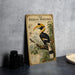 A vintage-style illustration of a hornbill bird, with text and illustrations, is displayed on a wall.
