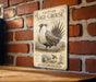 a vintage-style illustration of a Greater Sage-Grouse, a species of bird, mounted on a brick wall.