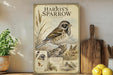 A framed illustration of a bird, likely a sparrow, is displayed on a shelf next to a wooden cutting board and some fruit.