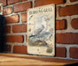 a vintage-style metal sign with an illustration of a seagull, mounted on a brick wall.