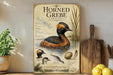 a poster or painting of a horned grebe, a type of water bird, with various illustrations and text providing information about the bird.