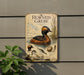 a vintage-style metal sign with illustrations and text about the Horned Grebe, a type of water bird, mounted on a wall.
