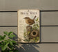 A vintage-style metal sign with a bird illustration and text, mounted on a wall next to a plant.