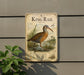 A metal sign with a detailed illustration of a bird, likely King Rail, standing in a natural setting.