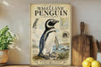 a framed illustration of a Magellanic penguin on a shelf, surrounded by various kitchen utensils and a potted plant.