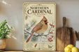 A vintage-style poster of a cardinal bird on a branch, surrounded by pine needles and berries, is displayed on a shelf next to a wooden cutting board and a potted plant.