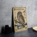 a wooden sign with illustrations and text about a Northern Pygmy- Owl, which is a type of owl.