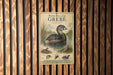 A vintage-style metal sign with illustrations and text, mounted on a wooden wall.
