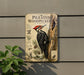 a vintage-style metal sign with illustrations and text about a woodpecker, mounted on a wall next to a plant.